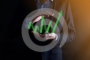 Businessman hold drawing on screen growing graph, arrow of positive growth icon.pointing at creative business chart with upward