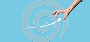 Businessman hold drawing on screen growing graph, arrow of positive growth icon.pointing at creative business chart with upward