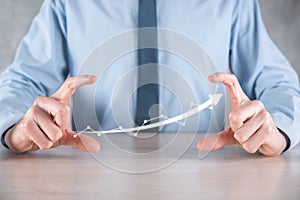 Businessman hold drawing on screen growing graph, arrow of positive growth icon.pointing at creative business chart with upward