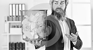 businessman hold full paper bin with crumpled papers. business and trash. man search crimpled paper in basket. ceo in