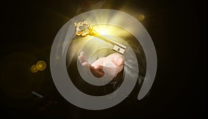 Businessman hold a gold shining key, business concept photo