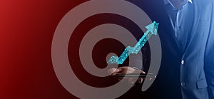 Businessman hold graph, arrow of positive growth icon.pointing at creative business chart with upward arrows.Financial, business