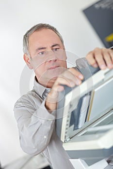 Businessman hold ink cartridge to put into printer