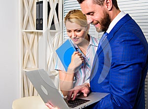 Businessman hold laptop surfing internet with colleague. Office business partner show information data statistics online