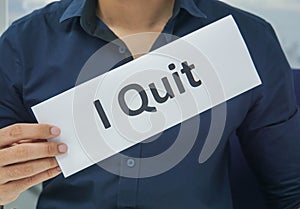 Businessman hold paper sheet of I quit as resignation letter from the office