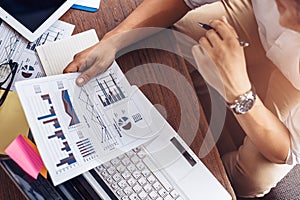 Businessman hold pen and working calculate data. document graph chart and report marketing. Business office concept