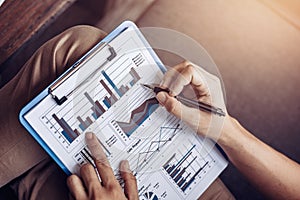 Businessman hold pen and working calculate data. document graph chart and report marketing. Business office concept