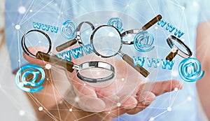 Businessman holding 3D rendering contact icon and magnifying glass in his hand