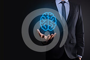 Businessman holding abstract brain and icon tools, device, customer network connection communication on virtual , innovative
