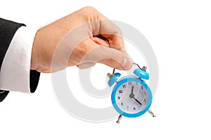A businessman is holding an alarm clock. Watch in hand. The concept of hourly pay, time. Late for work. Full or incomplete rate. O
