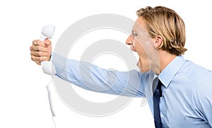 Businessman holding analogue phone isolated on white background