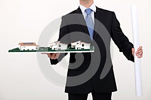 Businessman holding an architectural model