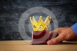 Businessman holding award trophy for show victory or winning first place