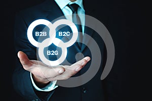 Businessman holding B2B, B2C, B2G business models. Business concept