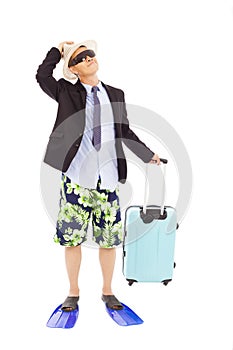 Businessman holding a baggage and look up