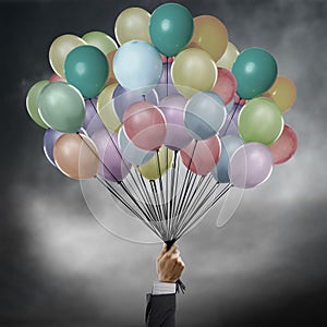 Businessman holding balloons