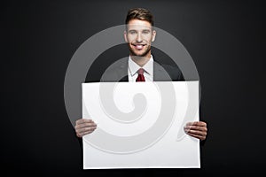 Businessman holding banner with copy space
