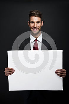 Businessman holding banner with copy space