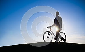 Businessman Holding Bicycle Silhouette Hill Concept