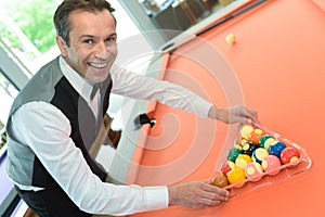 Businessman holding billiard balls