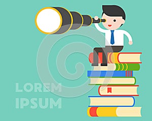 Businessman holding binoculars and sitting on stack of books, wi