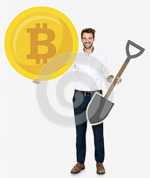 Businessman holding bitcoin cryptocurrency and mining concept icons