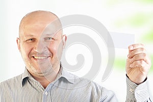 Businessman holding a blank business card