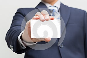 Businessman holding blank business card