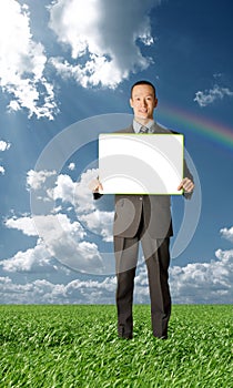 Businessman holding blank card outdoors
