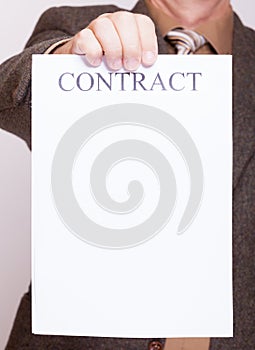 Businessman holding blank paper with sign contract