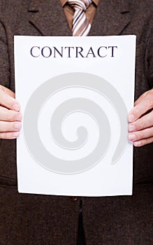 Businessman holding blank paper with sign contract