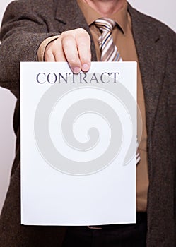 Businessman holding blank paper with sign contract