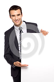 Businessman holding blank poster