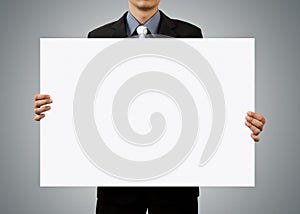 Businessman holding blank sign and hand