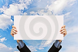 Businessman holding blank sign and hand in sky