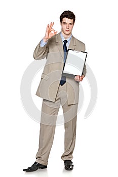 Businessman holding blank whiteboard showing OK