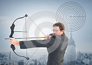 Businessman holding bow and arrow while aiming