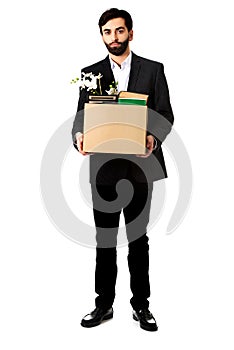 Businessman holding box with personal belongings.