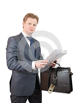 Businessman holding brief case and documents