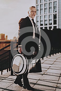 Businessman is Holding a Briefcase and Monowheel