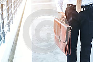 Businessman holding a briefcase travellers walking outdoors