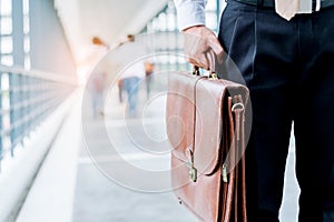 Businessman holding a briefcase travellers walking outdoors photo