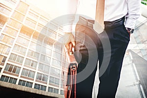 Businessman holding a briefcase travellers walking outdoors