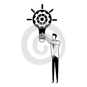 Businessman holding bulb with gear inside in black and white