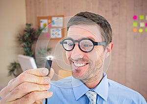 Businessman holding cable with flare in office