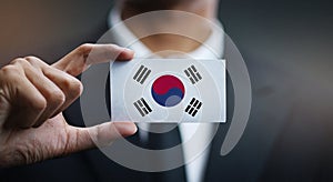 Businessman Holding Card of South Korea Flag