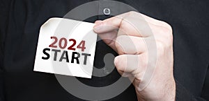 Businessman holding a card with text 2024 START, business concept