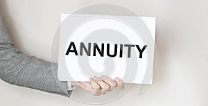 Businessman holding a card with text ANNUITY