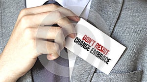 Businessman holding a card with text Dont resist change embrace