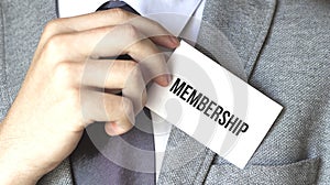 Businessman holding a card with text MEMBERSHIP